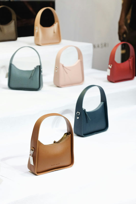 A group of purses sitting on top of a table