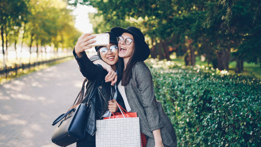 Two friends taking a selfie in a park.