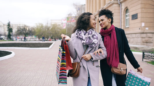 Two women walking with shopping bags