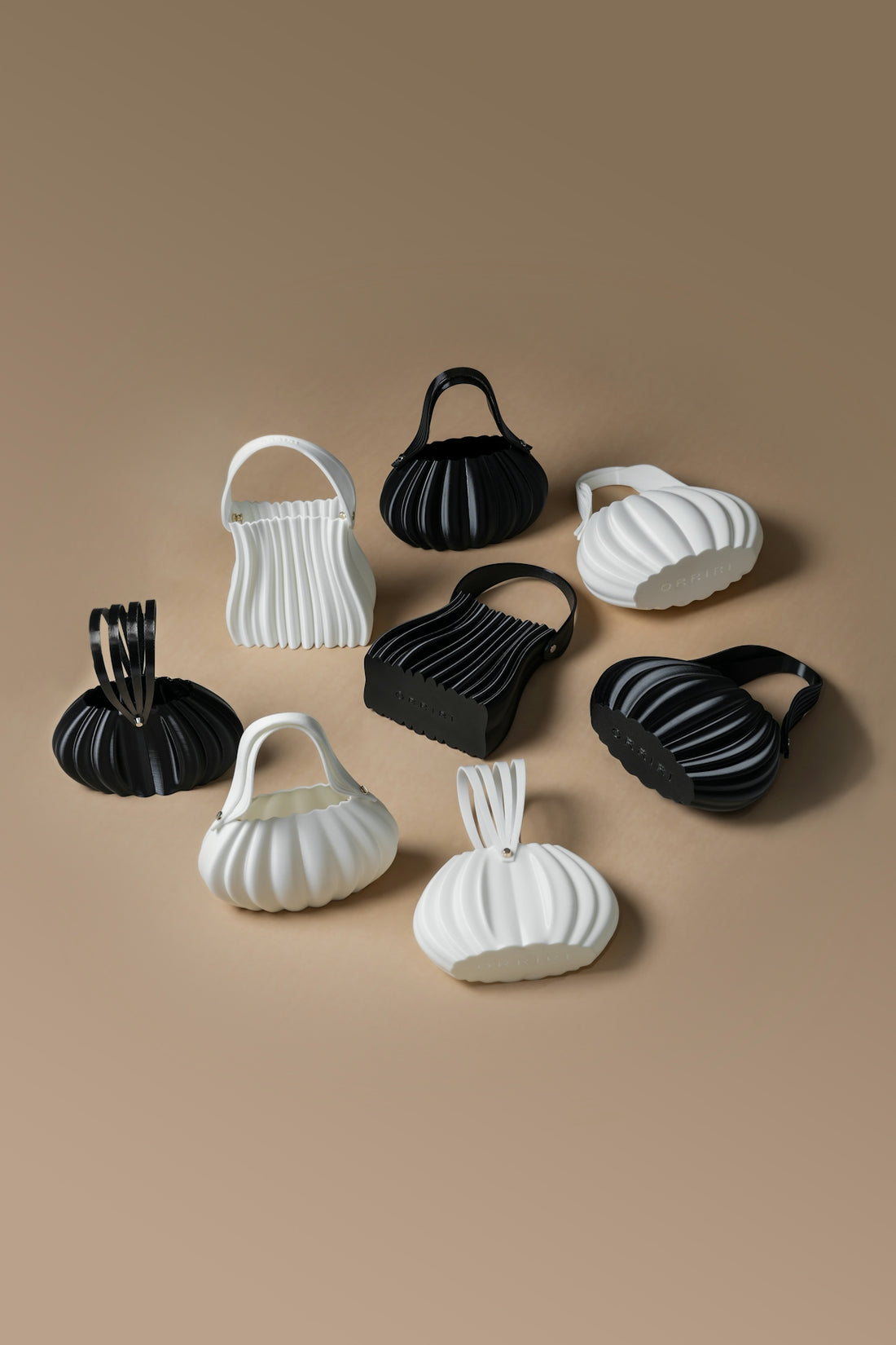 Collection of pleated handbags in black and white