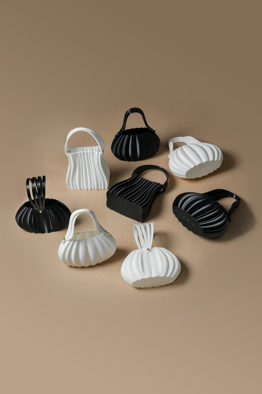 Collection of pleated handbags in black and white