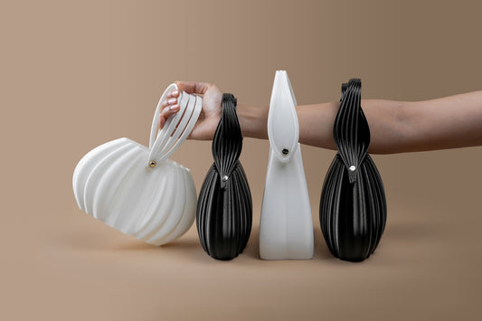 Four unique designer handbags on a neutral background